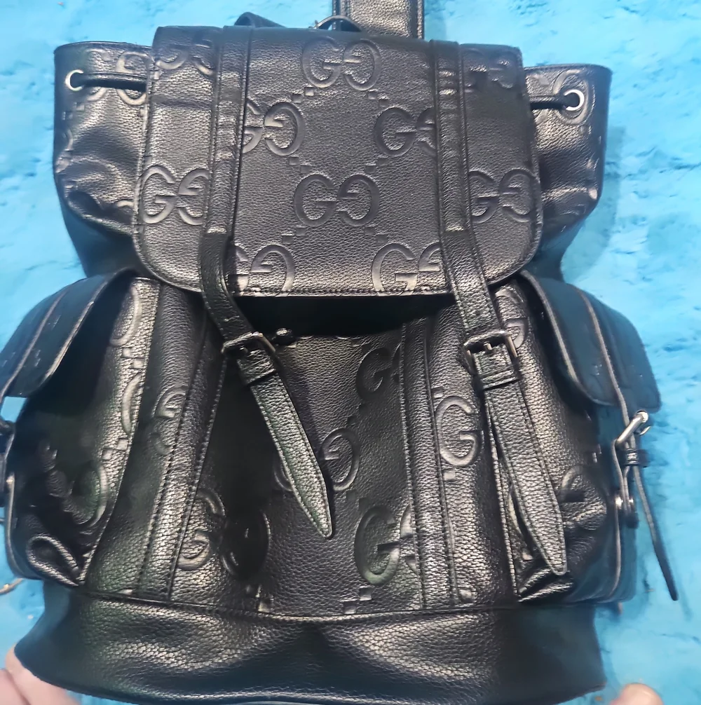 Gucci Black Embossed GG Leather Drawstring Backpack